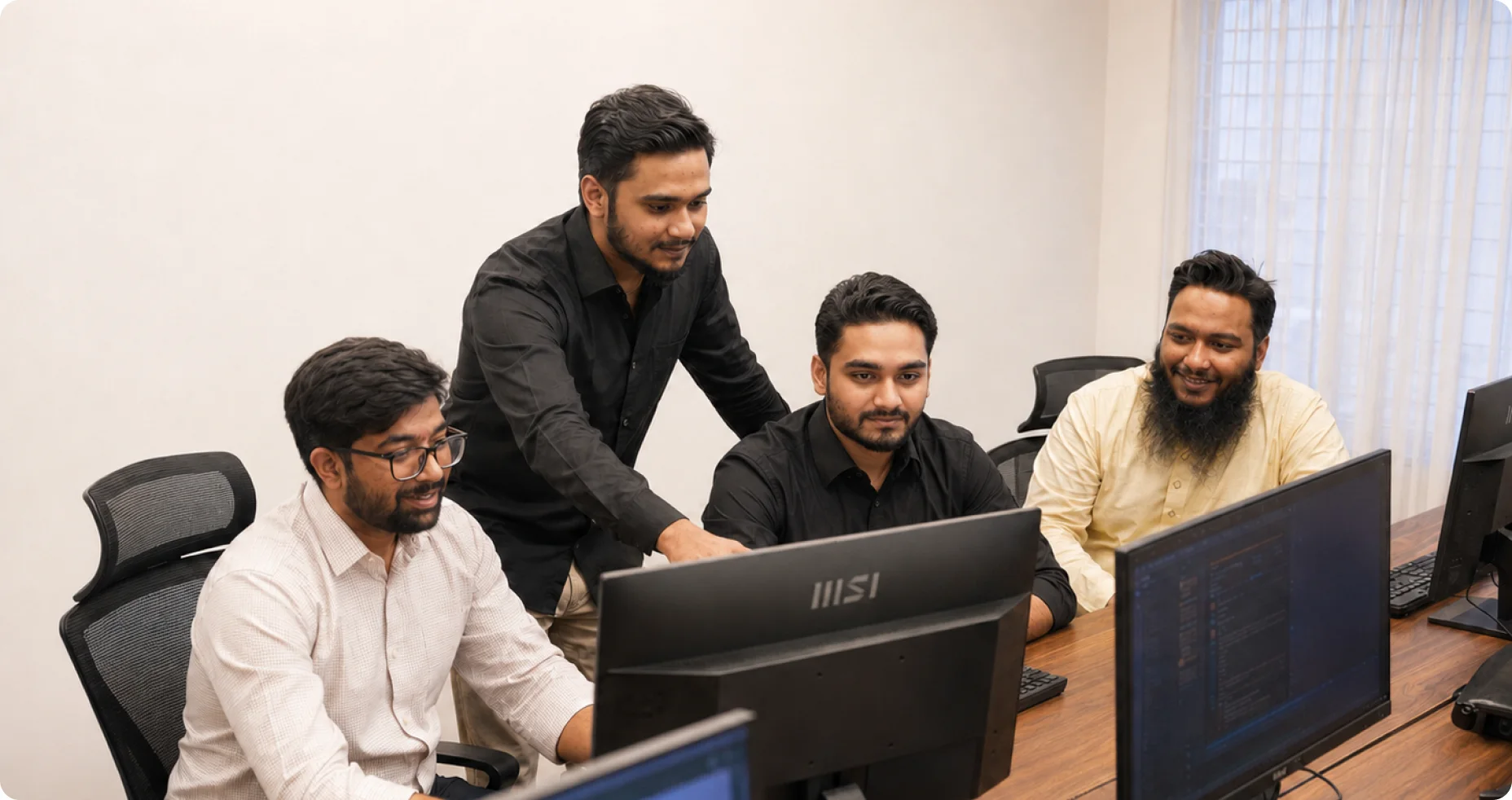 The ZenhCare team reviewing the platform together at a shared workstation